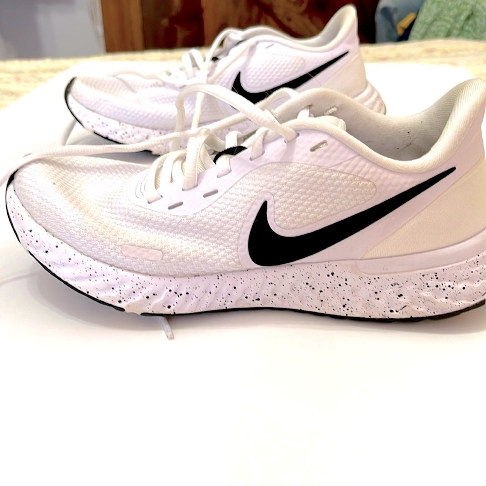 Nike Revolution black and white tennis shoes